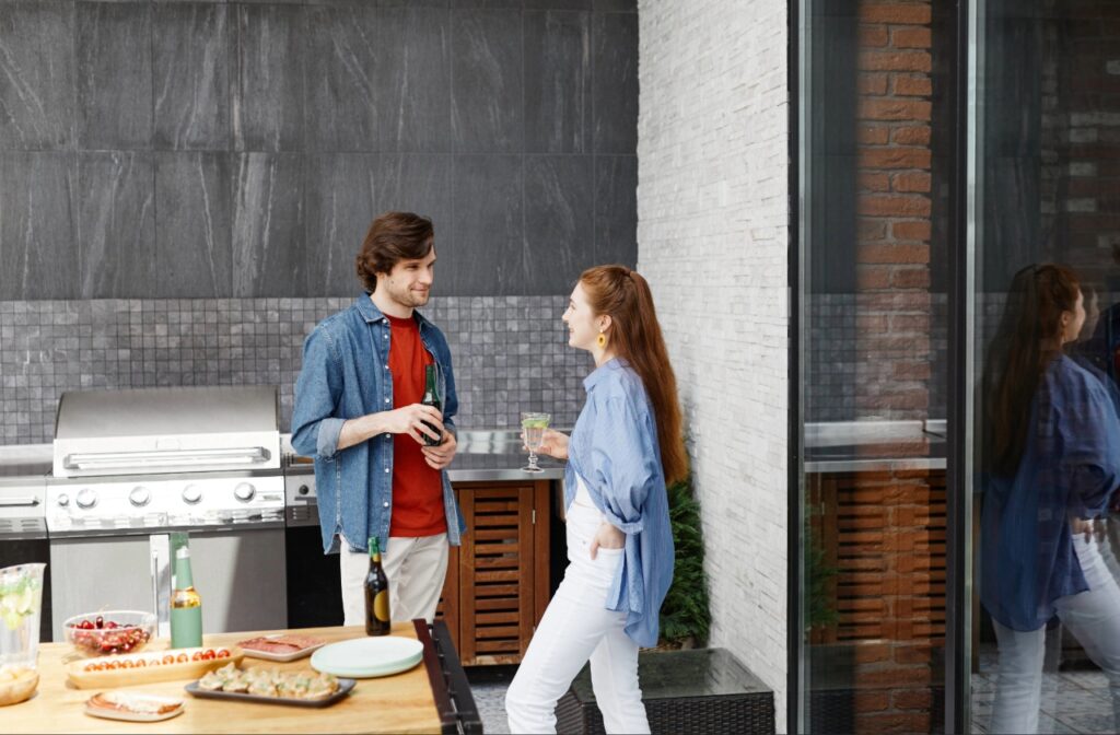 Outdoor kitchen cabinets, countertop, and built-in grill installed on a lanai