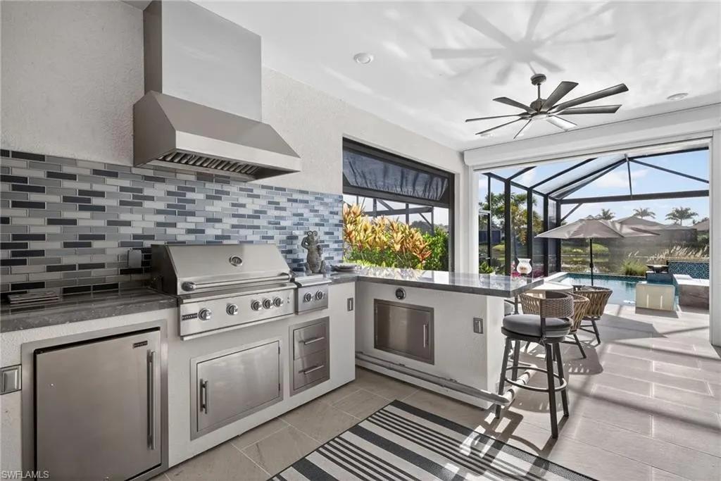 Covered lanai outdoor kitchen layout with cabinetry preparation space and seating