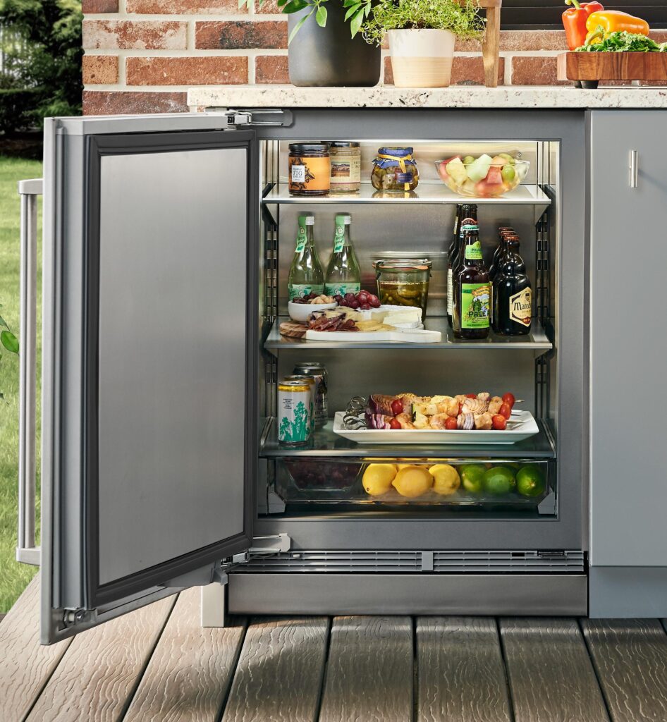 Outdoor refrigerator with shelves for ingredients, condiments, and food containers in an outdoor kitchen